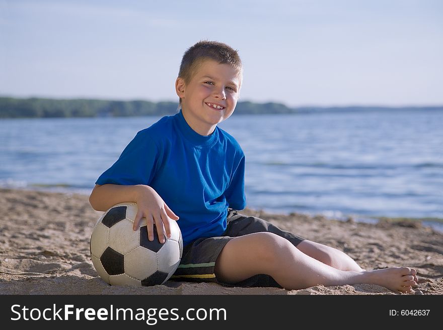 Boy playing with ball on the beach