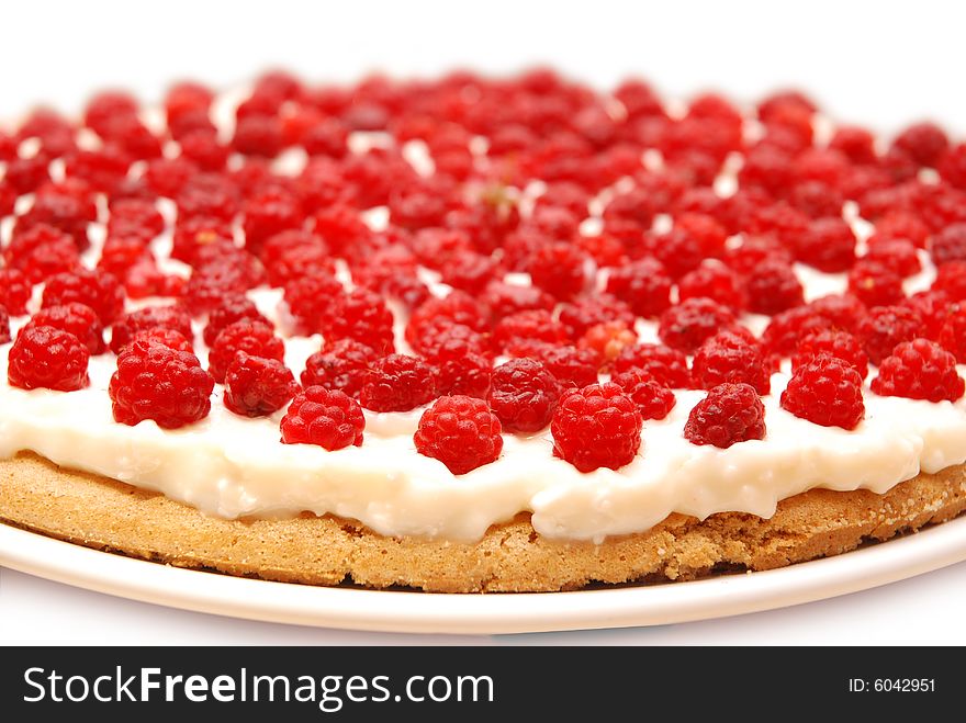 Appetizing raspberry tart on white plate.