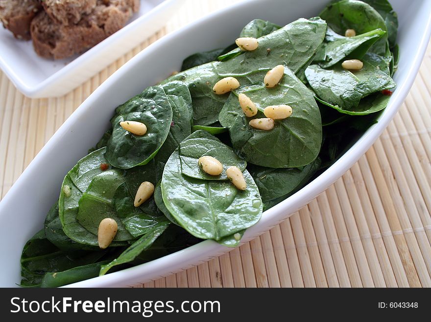 A fresh salad of spinach and pinecorns. A fresh salad of spinach and pinecorns