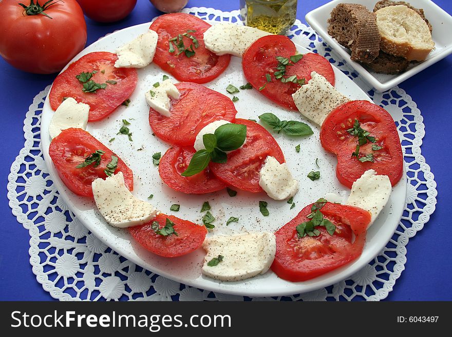 Some cheese and tomatoes on a plate