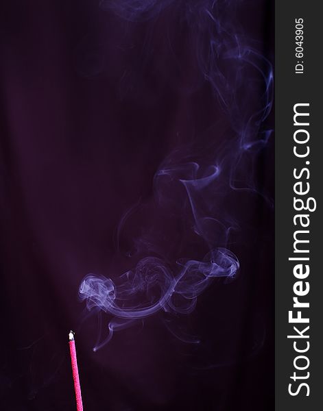 Pink aromatic stick with a smoke on a black. Pink aromatic stick with a smoke on a black