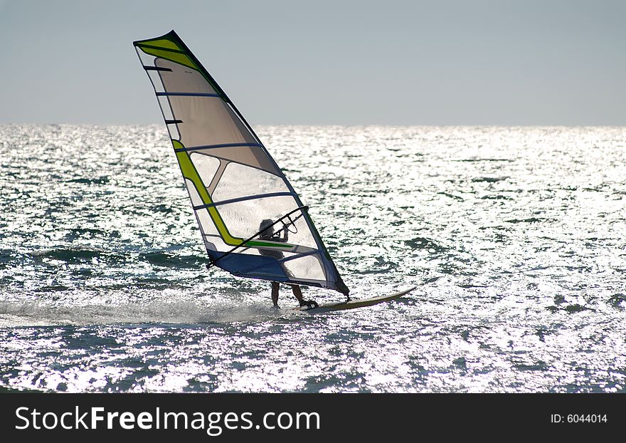 Man surfing in the afternoon on open sea. Man surfing in the afternoon on open sea