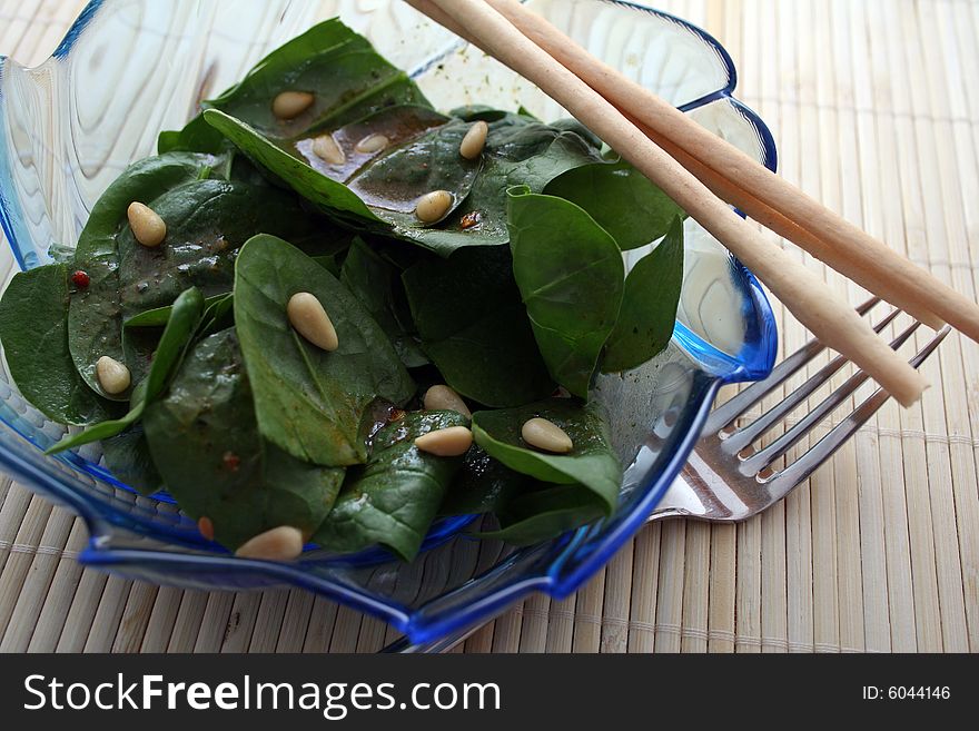 A salad of frech spinach with pine corns