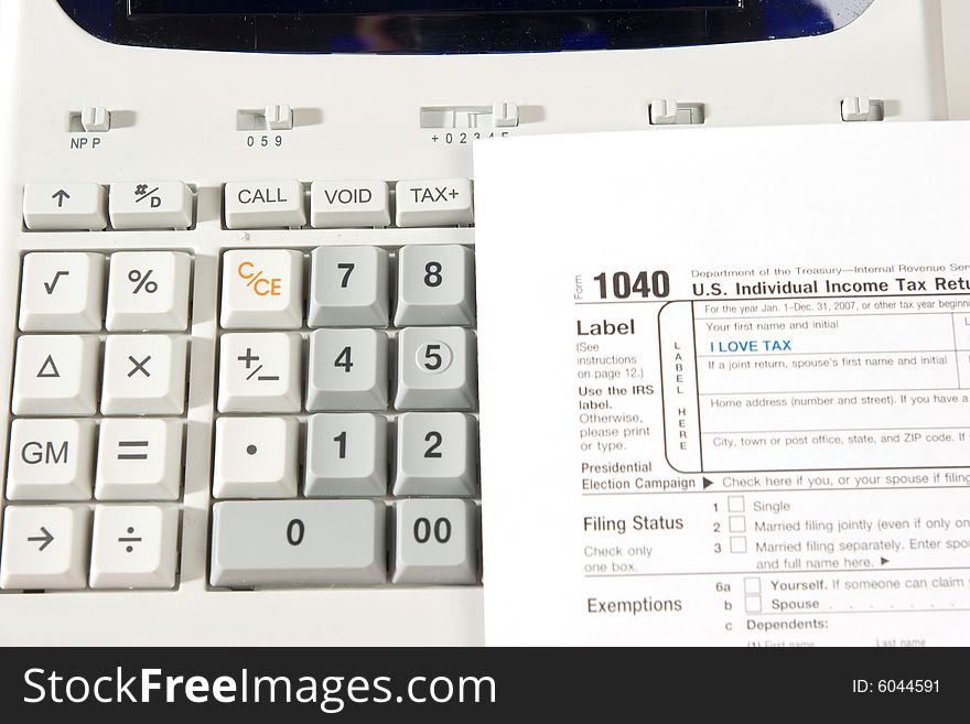 An image of tax return with a calculator to make the account. An image of tax return with a calculator to make the account