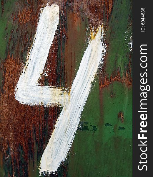 The figure four is drawn by a white paint on a rusty metal background.