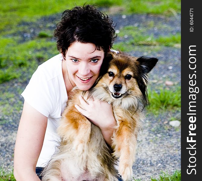 A woman cuddling her cute dog. A woman cuddling her cute dog