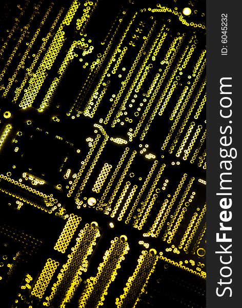 Yellow circuit board closeup lit from below through the board, creating a unique glow effect. Yellow circuit board closeup lit from below through the board, creating a unique glow effect.