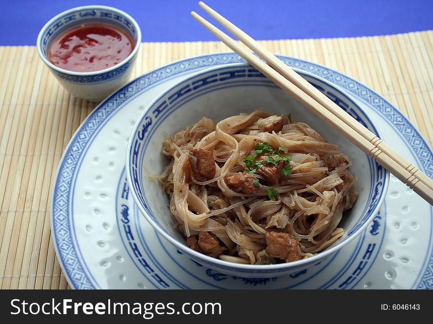 A chinese meal with mie noodles and meat. A chinese meal with mie noodles and meat