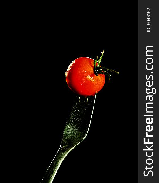 Cherry tomato on a silver fork