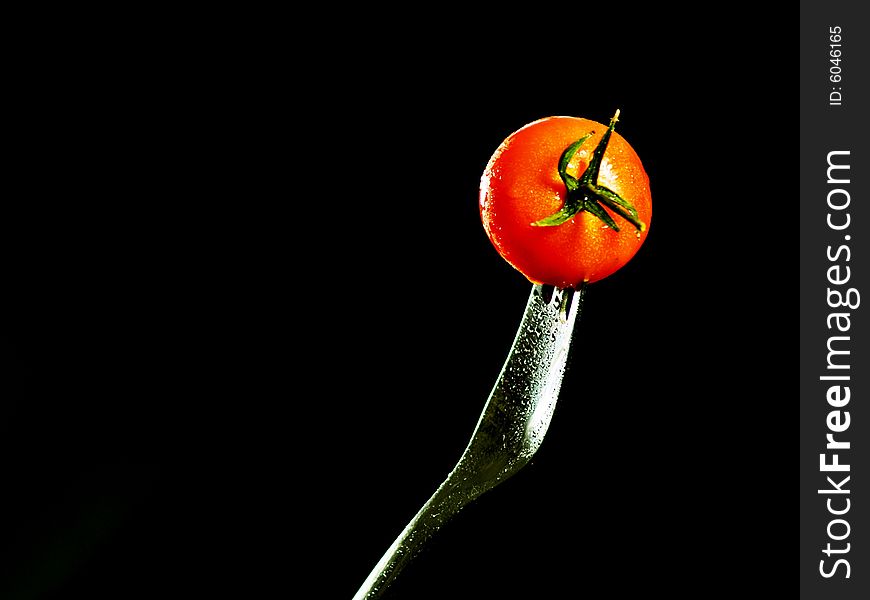 Cherry tomato on a silver fork
