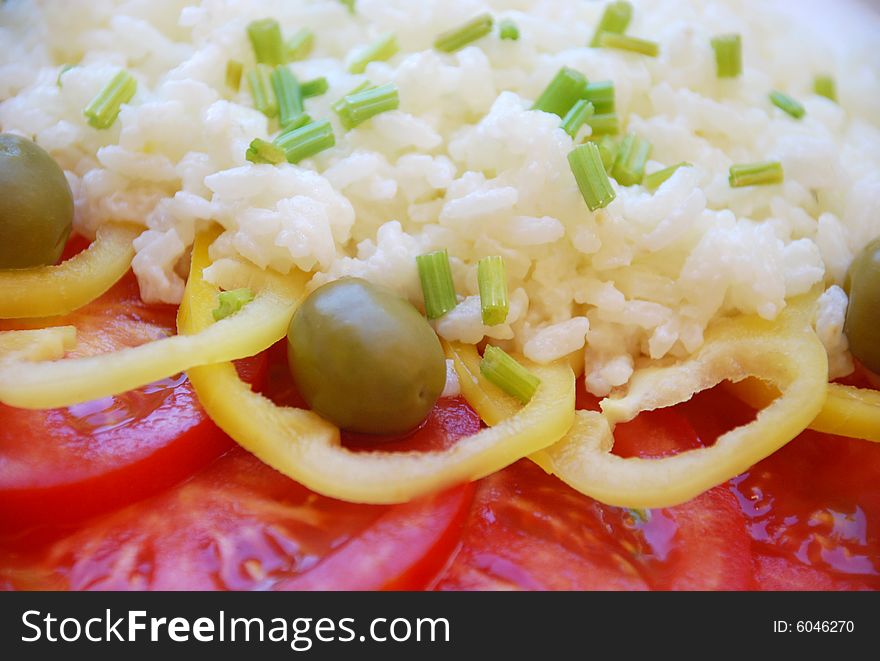 A detail of a salad with rice and olives. A detail of a salad with rice and olives