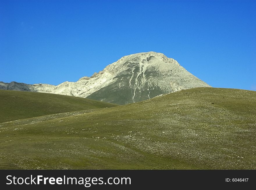 Magnificent view of a mountain with blue sky in the background.