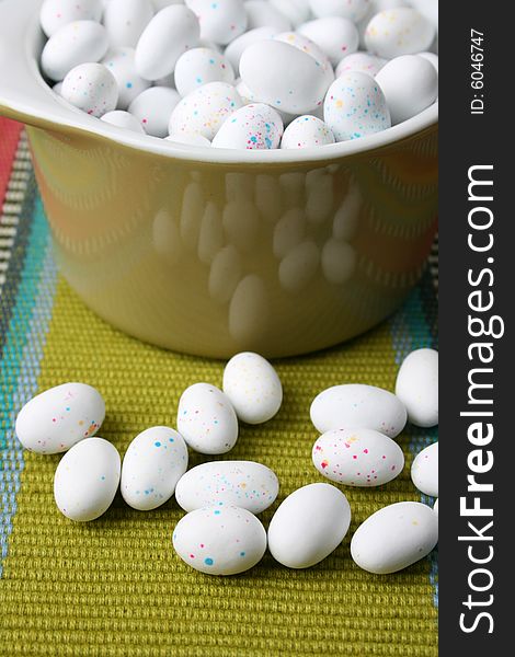 Miniature speckled easter eggs in a green bowl