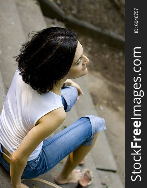 Portrait of pretty woman sitting on a staircase