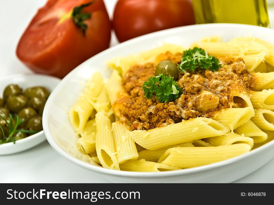 Spaghetti bolognese with parmesan cheese and olives.