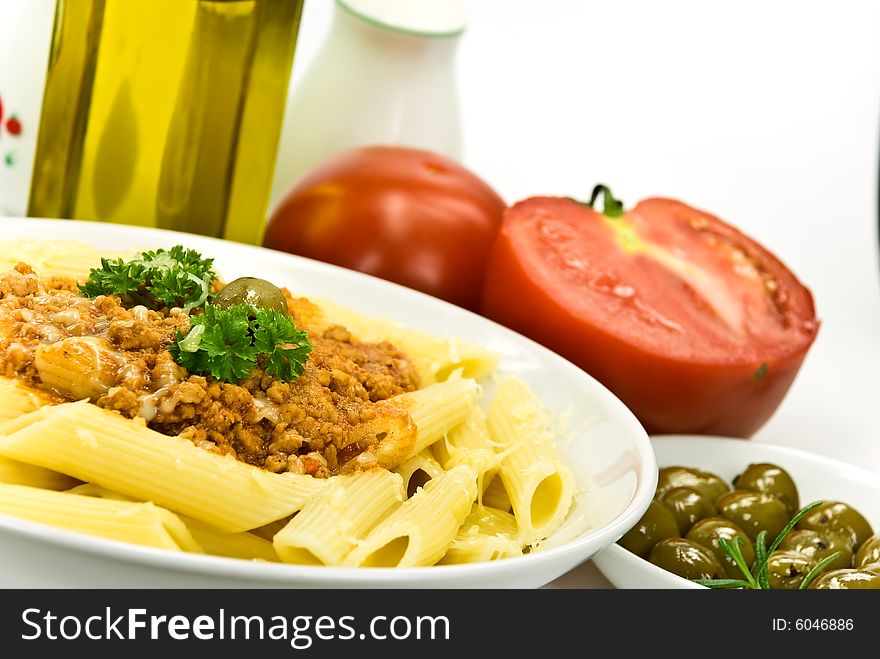 Spaghetti bolognese with parmesan cheese and olives.