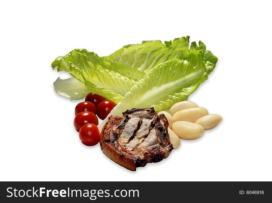 Grilled pork chop and salad with dark cherry tomatoes, potatoes and lettuce on a white background.