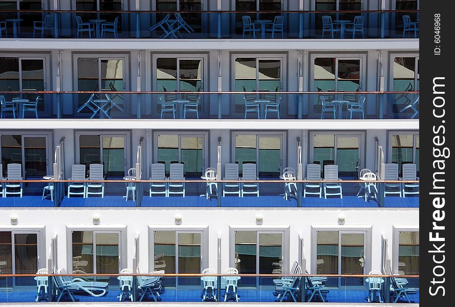 The view of empty balconies with chairs on a cruise liner. The view of empty balconies with chairs on a cruise liner.