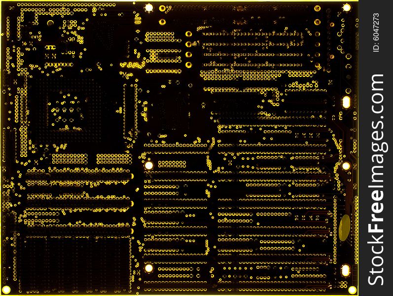 Yellow motherboard board lit from below through the board, creating a unique glow effect. Yellow motherboard board lit from below through the board, creating a unique glow effect.