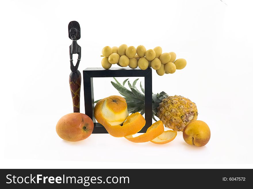 Composition - tropical fruit and a wooden figure of the African woman. Composition - tropical fruit and a wooden figure of the African woman