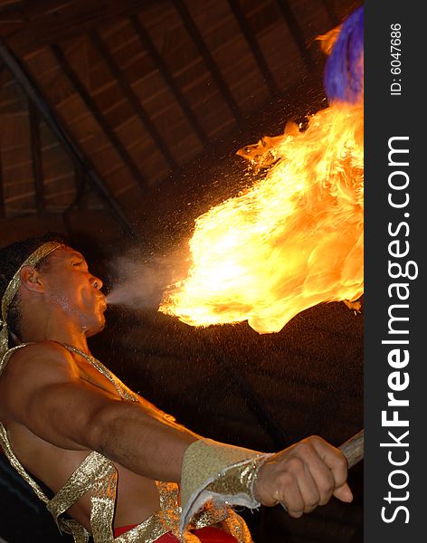 Fire spitting artist holding a torch. Fire spitting artist holding a torch