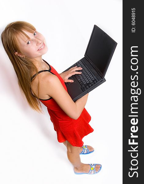 Pretty teenage girl with laptop, isolated over white