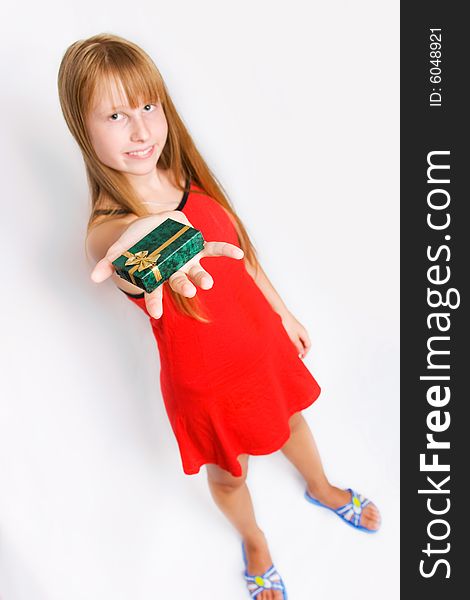 Pretty teenager girl in red dress holding gift box
