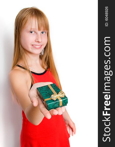 Pretty teenager girl in red dress holding gift box