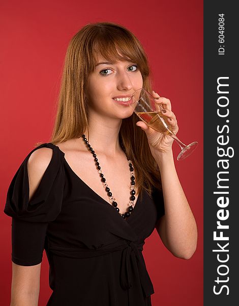Attractive girl with champagne glass isolated on red background