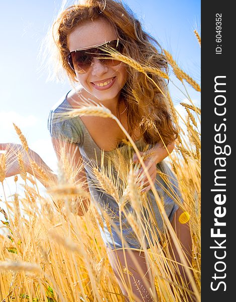 Beautiful woman in wheat field at sunny day. Beautiful woman in wheat field at sunny day