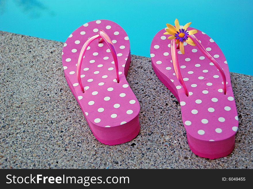 Pair of summer shoes at poolside. Pair of summer shoes at poolside.