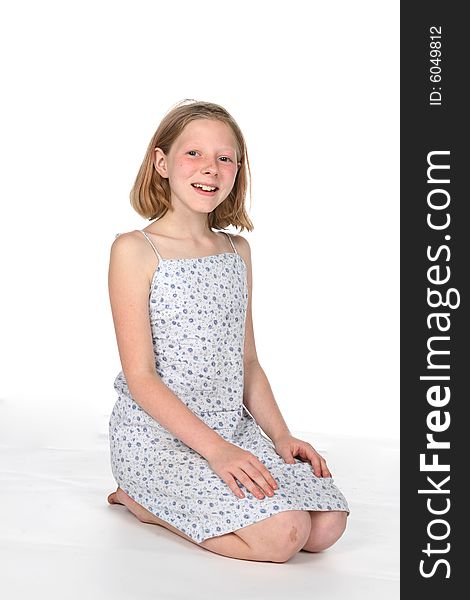 Young girl on knees, smiling. Young girl on knees, smiling