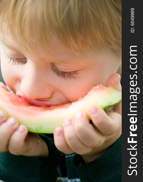 Boy savors the last bites of watermelon. Boy savors the last bites of watermelon