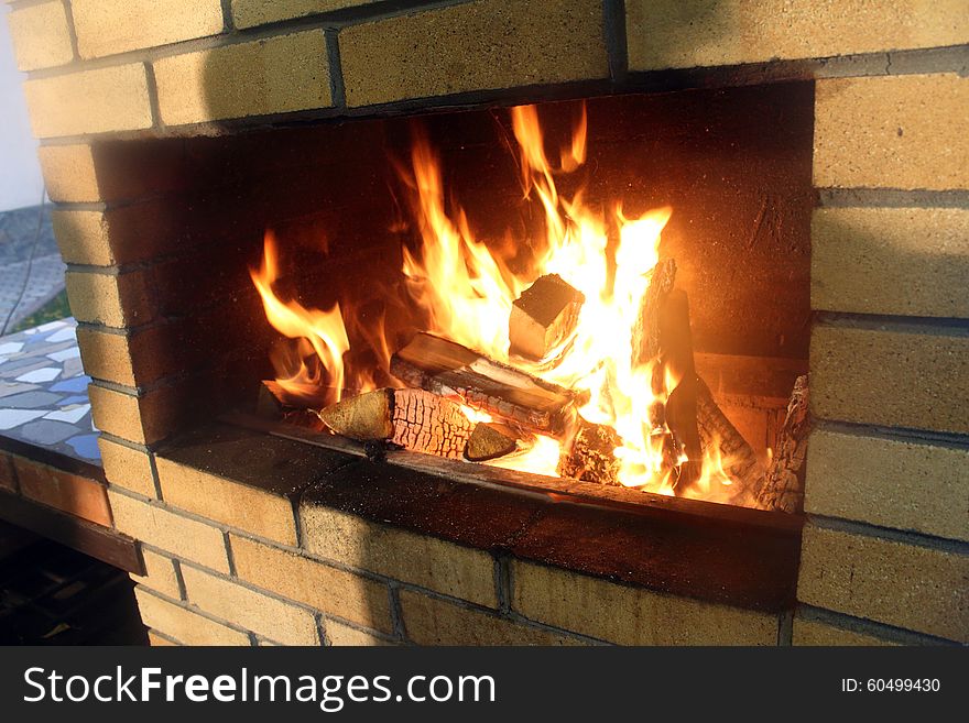 Brick fireplace with burning fire