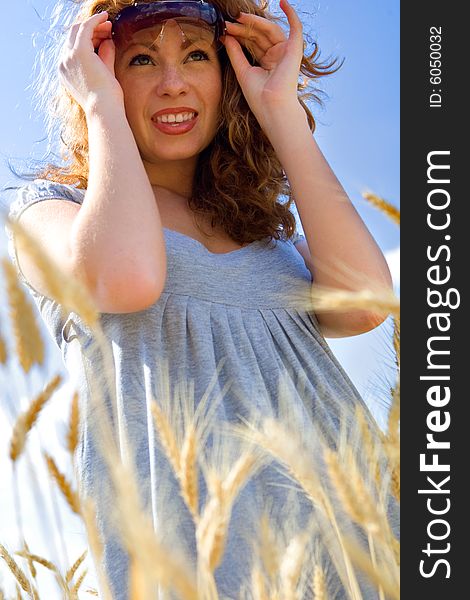 Beautiful woman in wheat field at sunny day. Beautiful woman in wheat field at sunny day