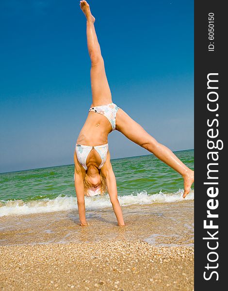 Girl exercising at sea beach