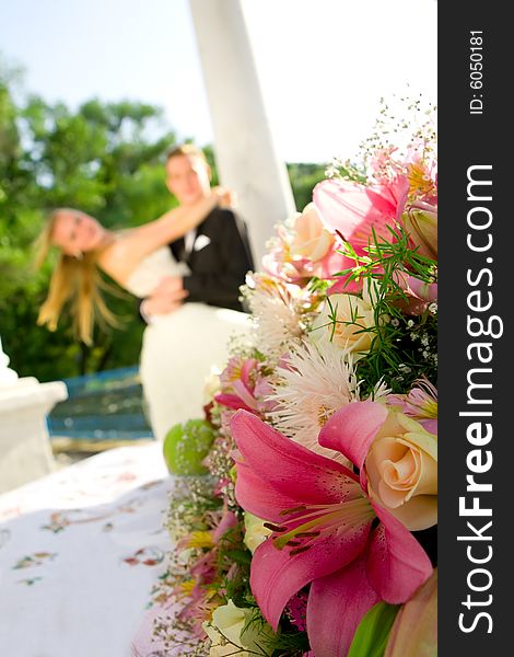 Colorful wedding shot of bride and groom with flowers on front. Colorful wedding shot of bride and groom with flowers on front