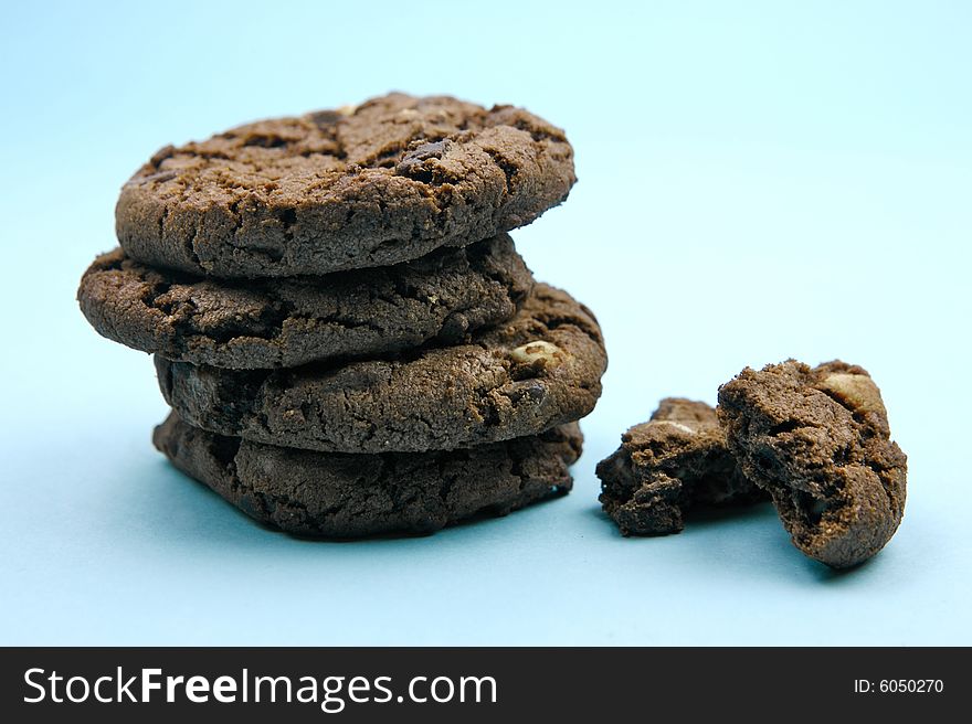 Choc chip cookies isolated against a blue background