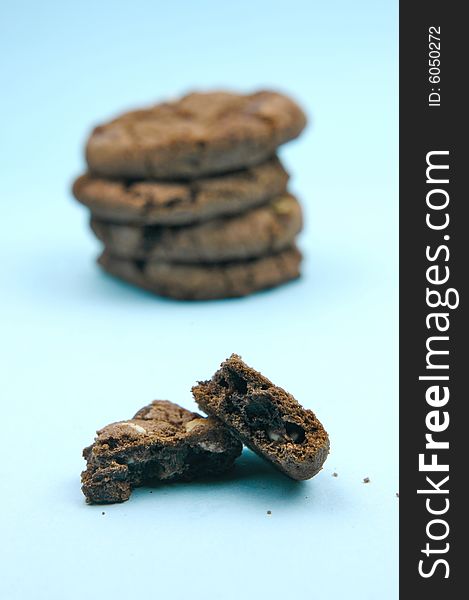 Choc chip cookies isolated against a blue background