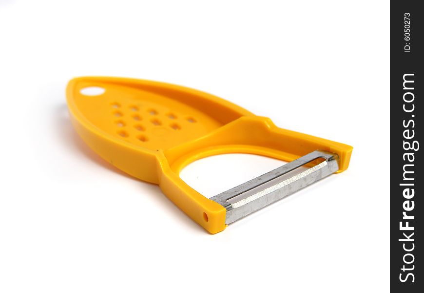 Yellow potato peeler and grater on white background