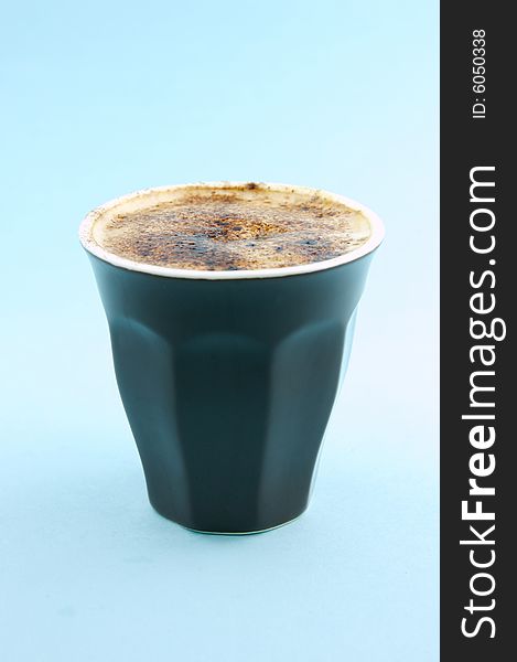 Cappuccino isolated against a blue background