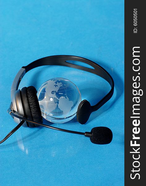 Globe and headphone isolated on blue background. Globe and headphone isolated on blue background