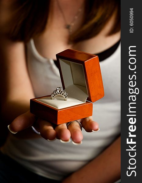 A gorgeous white gold diamond engagement ring presented in a warm wooden box. A gorgeous white gold diamond engagement ring presented in a warm wooden box.