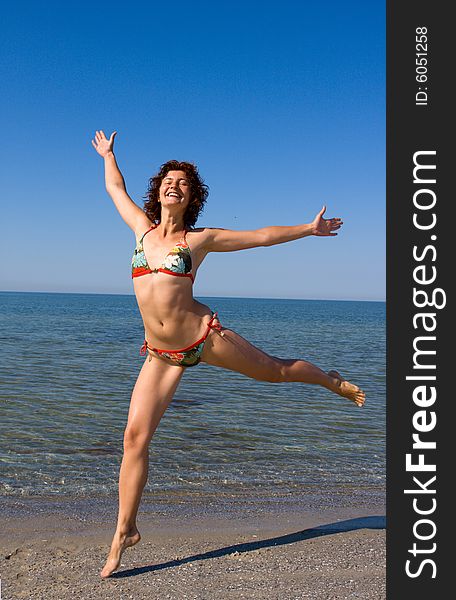 Happy Smiling Girl Jumping At Sea Beach