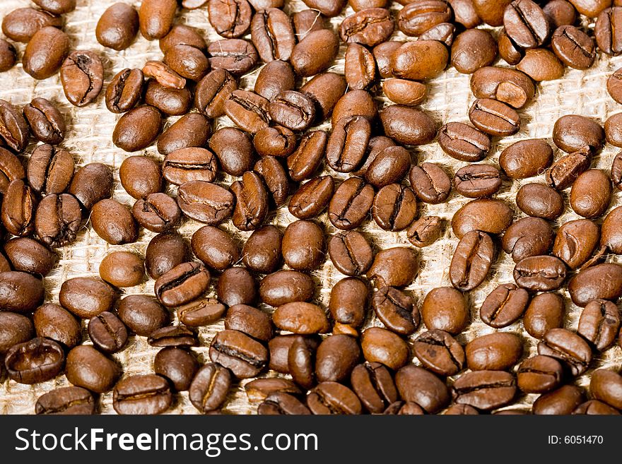 Coffee beans background on the textile jute canvas