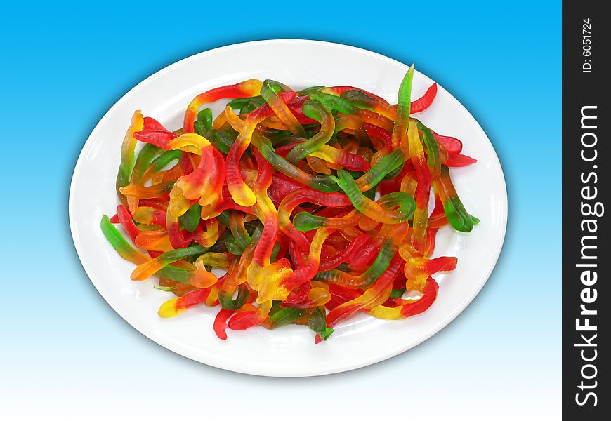 A plate of colorful worm shaped jelly candies. Including clipping path.