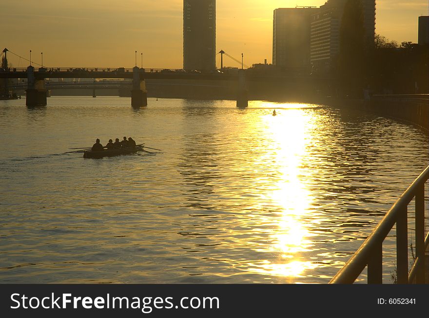 Rowers training to the dusk in the River Main, Frankfurt. Rowers training to the dusk in the River Main, Frankfurt.