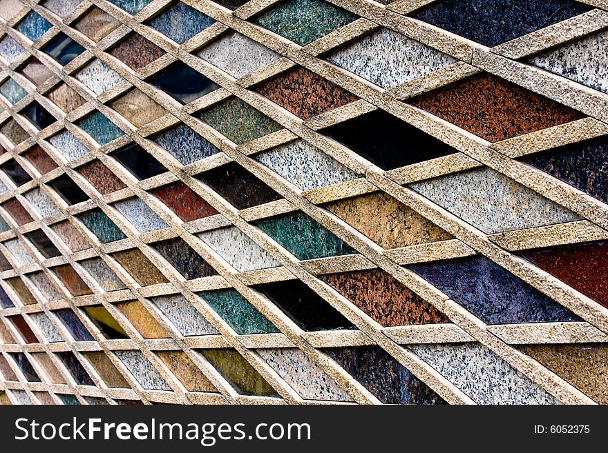 Creative tile arrangement on a wall where the color and texture interplay is focused within by rules of linear geometry. Creative tile arrangement on a wall where the color and texture interplay is focused within by rules of linear geometry.