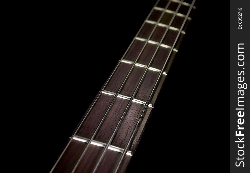 Guitar strings on plain black background