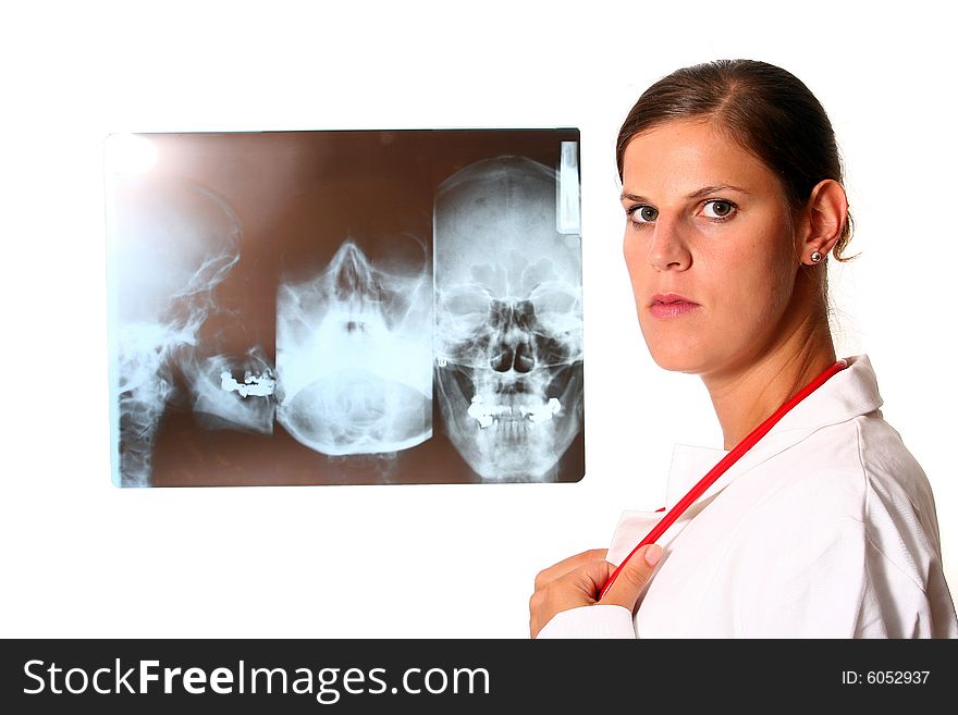 A beautiful young doctor with a red stethoscope and a xray image in the back. Isolated over white. A beautiful young doctor with a red stethoscope and a xray image in the back. Isolated over white.